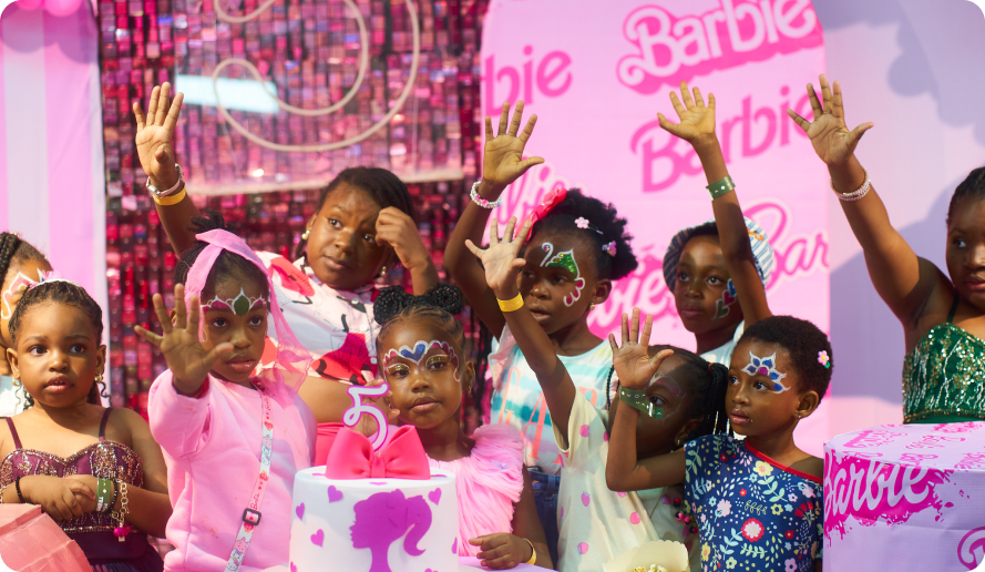 Kids celebrating at a Barbie-themed party